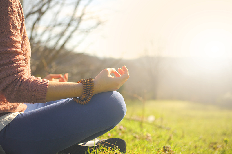 Meditating woman having a divine moment in nature